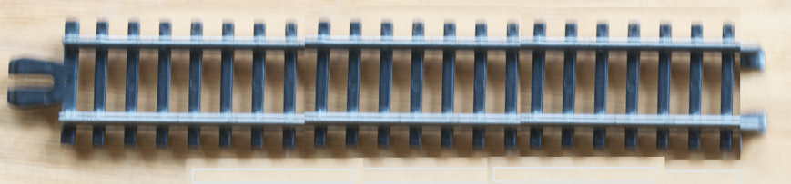 Picture of a toy plastic railroad track unit